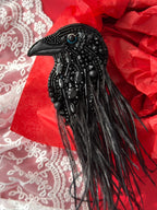 Hand embroidered black raven brooch with black glass beads and crystals, and black ostrich feathers. A bold gothic statement accessory, perfect for jackets, coats, and dark academia style lovers.