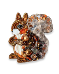 Decorative brooch shaped like a squirrel with beads and sequins on a white background