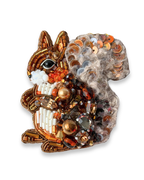 Decorative brooch shaped like a squirrel with beads and sequins on a white background