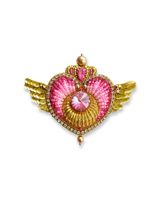 Crisis Moon brooch with pink Swarovski crystal in center and golden beaded wings.
